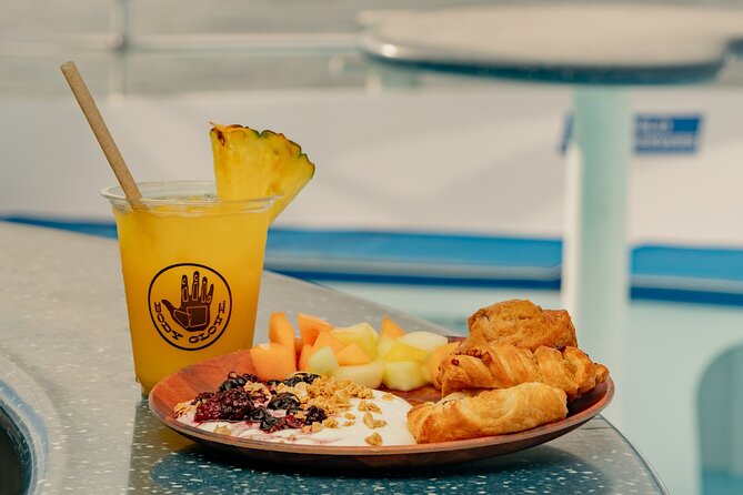 Deluxe Snorkel & Dolphin Watch Aboard a Luxury Catamaran from Kailua-Kona - Slides, jumps, and floating toys