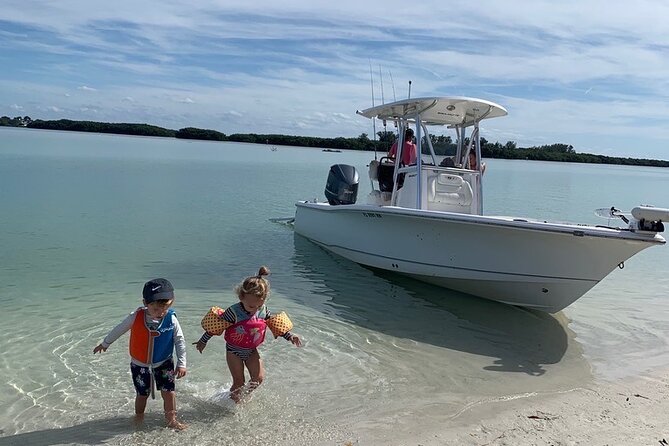 Private boat offering dolphin watching, island excursions and nature tours - Shell Island, sand dollars, and shallow water
