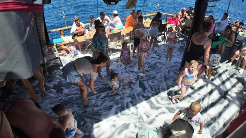Side: Dolphin Boat Tour With Lunch Foam party Swimming - First swim stop and the start of the music